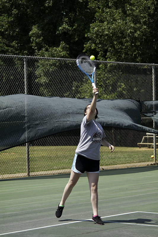 Fifteen year old girl taking tennis lessons. (MR)
