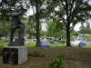 Protestors representing the Coalition to Occupy Wall Street South set up camp in Marshall Park in Charlotte, North Carolina during the Democratic National Convention, 2012. A statue of Martin Luther King, Jr. is featured in this park just above where protestors are camping.