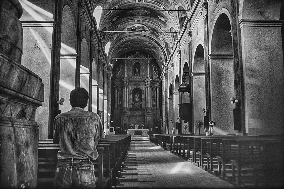 Man in prayer at a church in Santa Fe, Argentina.