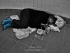 Man sleeping in subway hall.